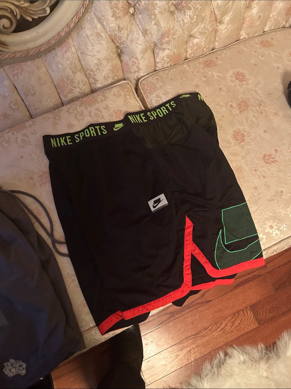 Nike Men’s Black Athletic Shorts with Red Hem and Green Logo